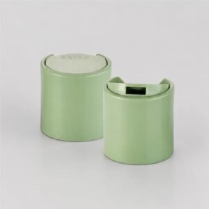 Anodized silver aluminum disc top cap in open and closed positions for cosmetic lotion bottles